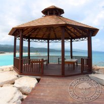 Ipe boardwalk along the picturesque Jamaican coastline that leads to a beautiful Ipe Gazebo .