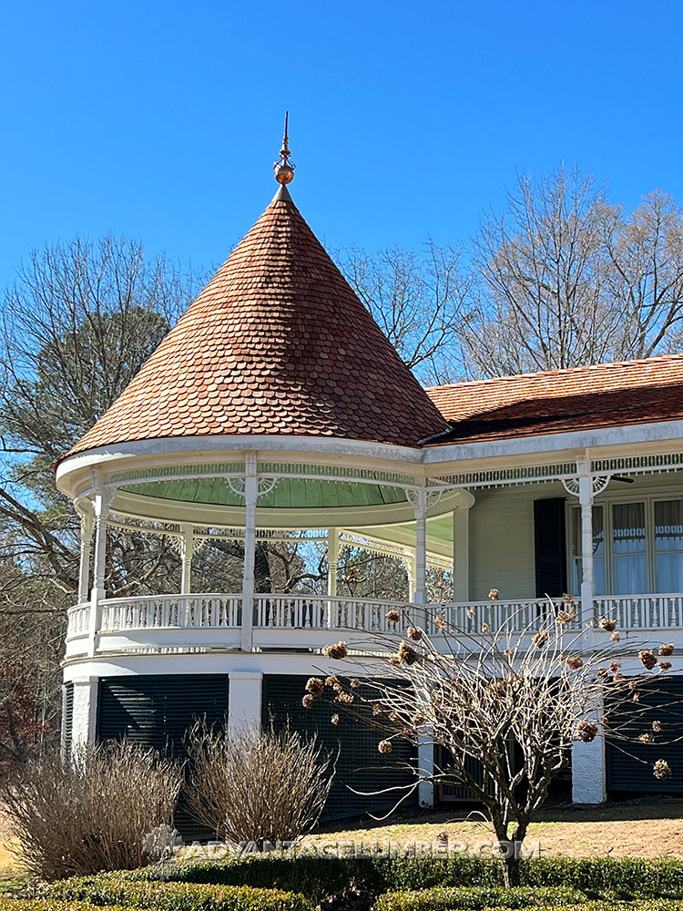 Newly installed wallaba roofing shingles on a wraparound porch.