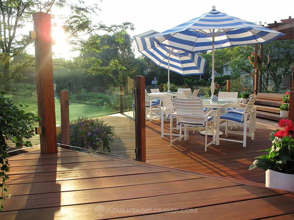 cumaru deck with glass panel railings and umbrellas